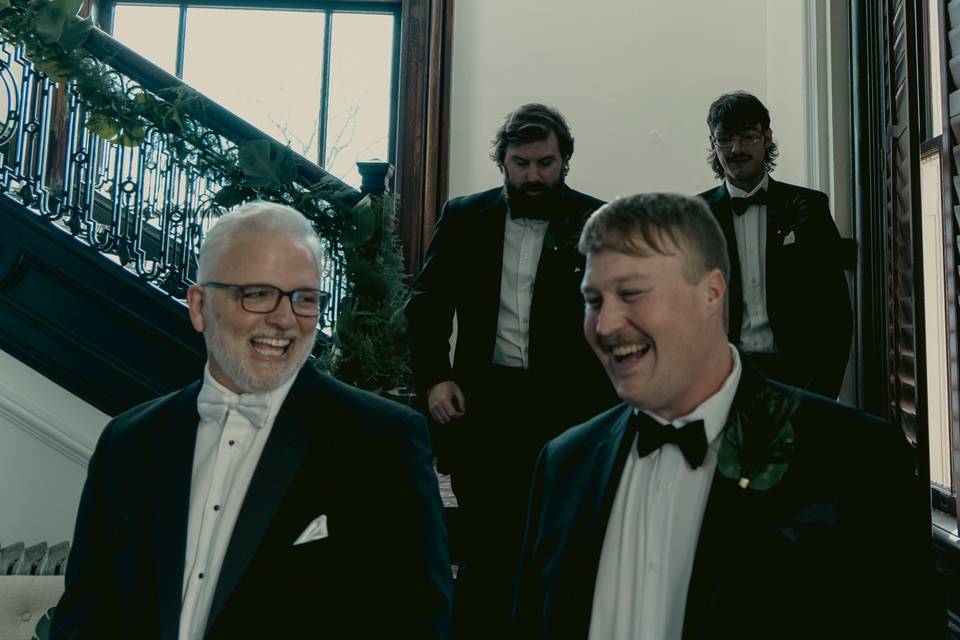 Groom party laughing on stairs