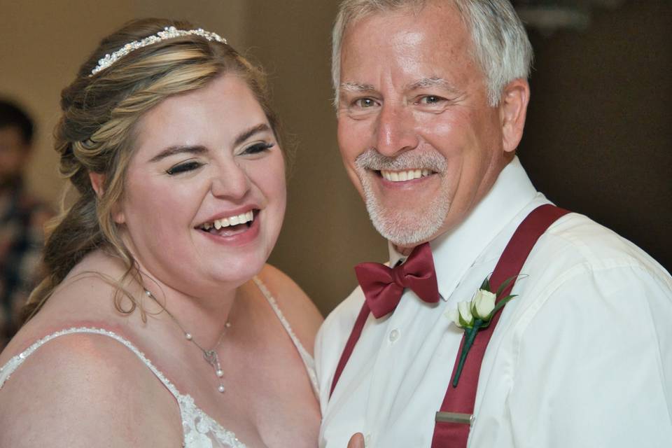Bride laughing with dad