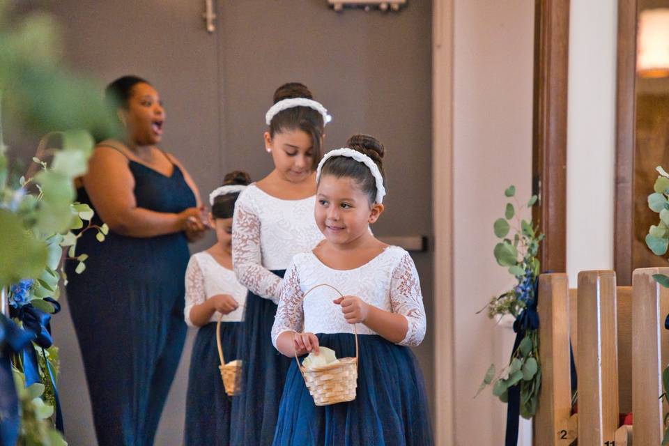 Flower girls walking in aisle
