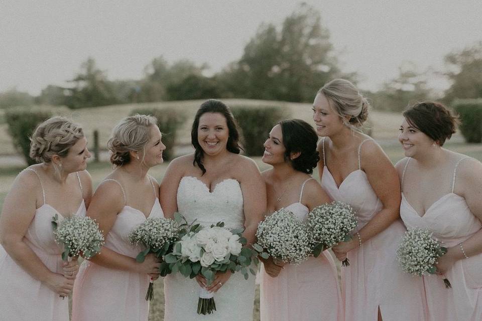 Bridal bouquet and bridesmaids’ bouquets designed by L.A. Flowers, Inc.Photo taken by Alexander Richie Photography.