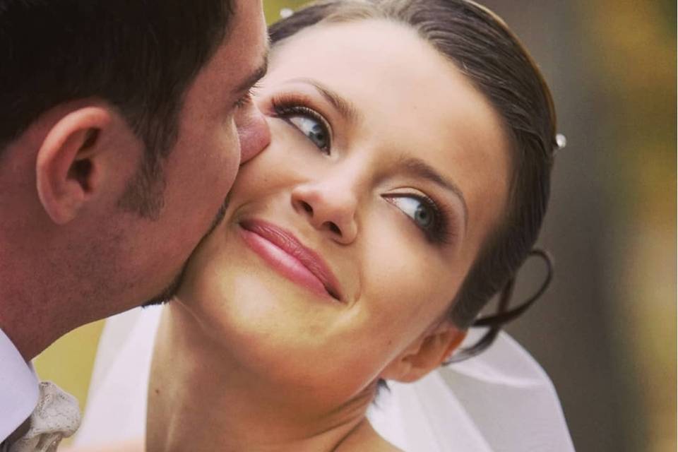 Groom kissing his bride