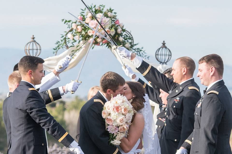 The kiss and the sword ceremony @southernhillsgolfclub with Judy Irving / Wedding Vows Las Vegas officiating. Photo by KMH Photography