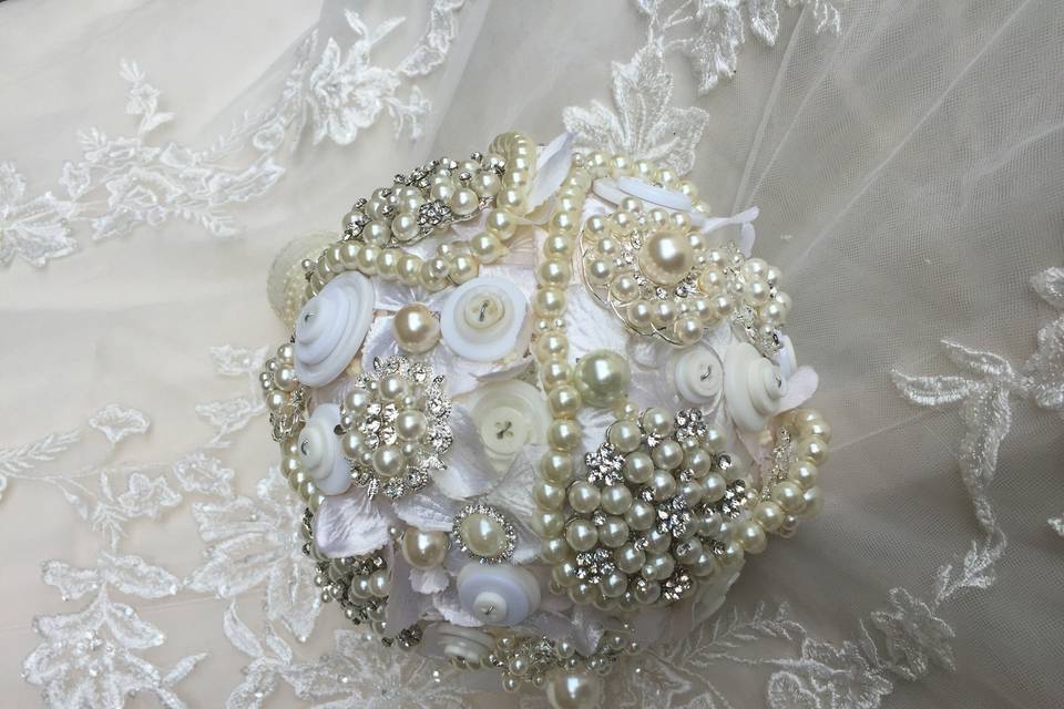 Pearl , Brooch , and button bouquet. With pearlized hydramgea petals underneath