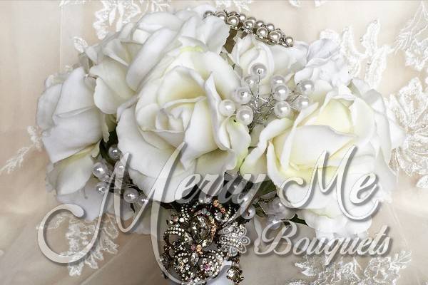 This bouquet is made with brooches and true touch roses