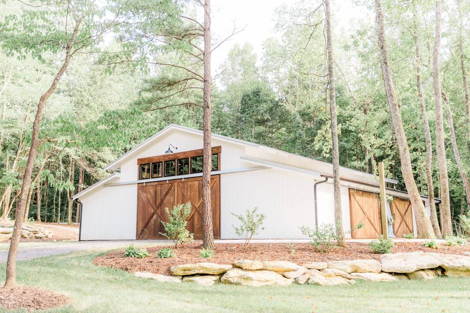 Barn-style estate with wood surroundings