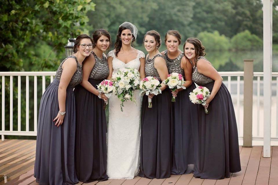 Gorgeous bride with her bridesmaids. Updo & Makeup Application