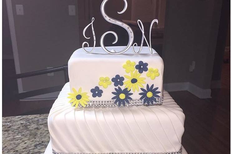 Square wedding cake with blue and yellow flowers
