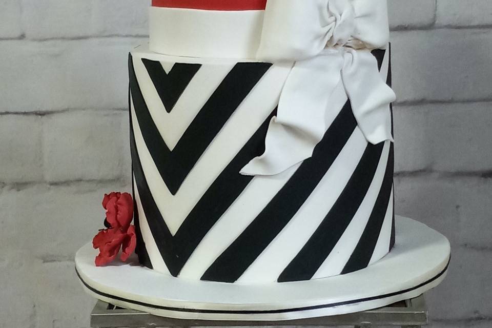 2 tiered Louis Vuitton birthday cake, iced in buttercream, with fondant  accessories, lettering and fondant accented stripes