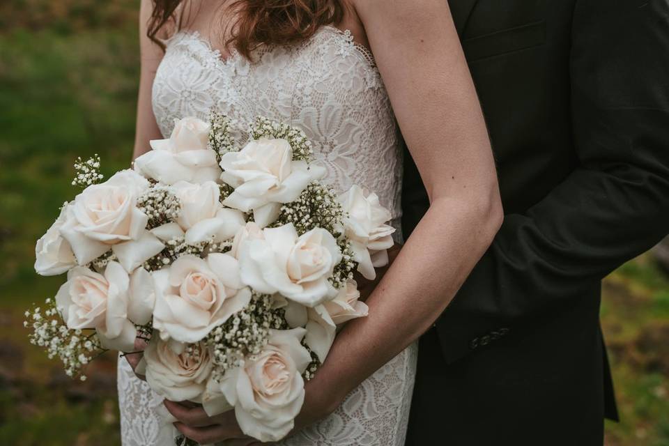 Couple posing with white flowe