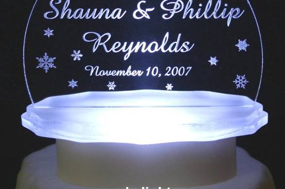 Lighted Personalized Winter Snowflake Cake Top.  Personalized with couple's names & wedding date.  Color lights available, as well as the RGB color changing light. Other Winter Themes Available at cakelights.com