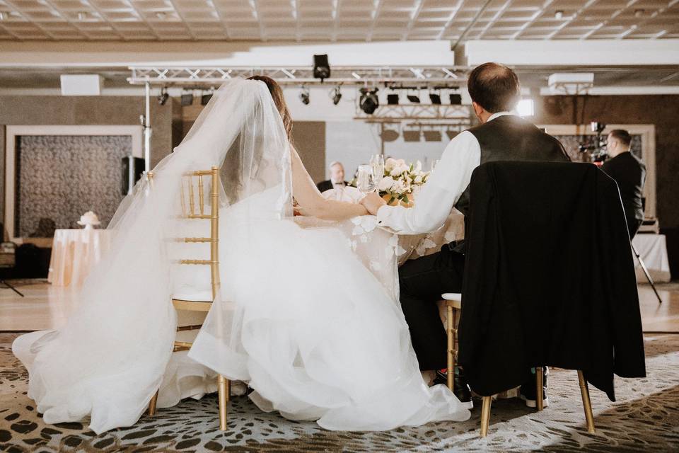 Bride and groom seated for dining