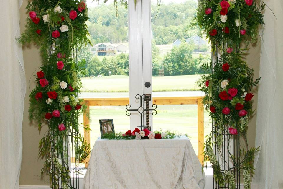 Altar surrounded by roses and greenery