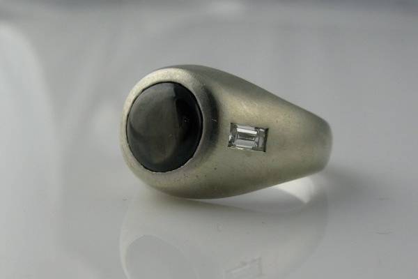 Masculine and wearable. Perfect for the groom who wants to wear a wedding ring beyond a simple band. Can be made with any center stone in any color/type metal.
