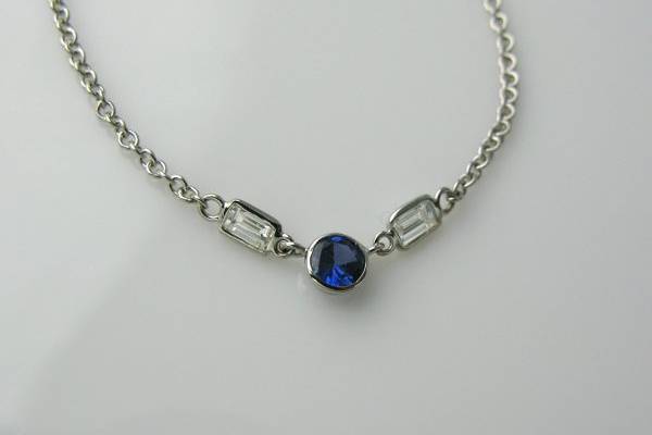 Something old... something new.... nothing borrowed.. something Blue! Used existing diamond baguettes and purchased a new cornflower blue sapphire to make this elegant new necklace.