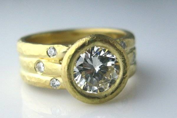 2ct diamond set in 18K Gold with diamond accents in band. Hand hammered. Can be made with any size stone.