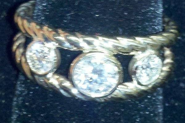 Three ideal cut diamonds bezel set in 14K yellow gold with rope bands. 1 ctw G/SI1 diamonds were used. Center stone is .50 each side stone .25ct. Ring can be made to your specifications.