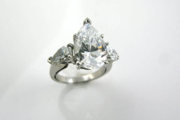 4 ct pear center diamond H/SI2 with .75ct accent stones. Set in platinum. Available in all shapes and sized diamonds.