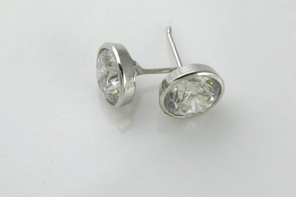 Bezel set diamond stud earrings set in platinum. Shown here with 1.5 ct G/SI2 diamonds (3 ctw) Can be made to accommodate any size diamond or stone. 1-2 week delivery.