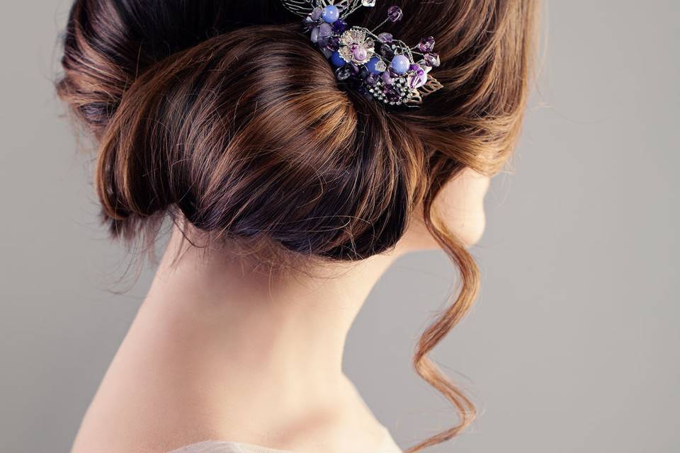 Neat low bun pinned with elegant broach