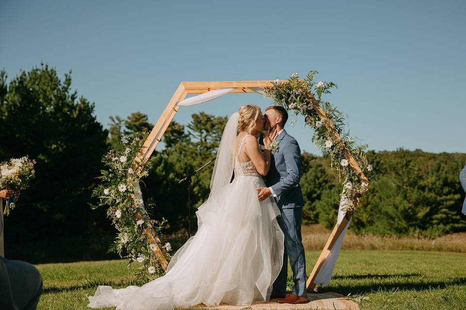 Outdoor ceremony kiss.