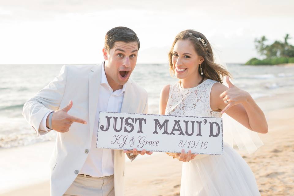 Couple just Maui'd on the beach in South Maui, Hawaii.