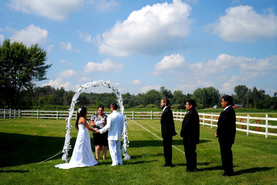 Powder-puff clouds decorate the sky on their wedding day! Ceremony held in our corral.