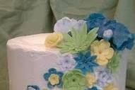A great retro colored cake with a nod to the classic style with the cascade of hand made flowers.