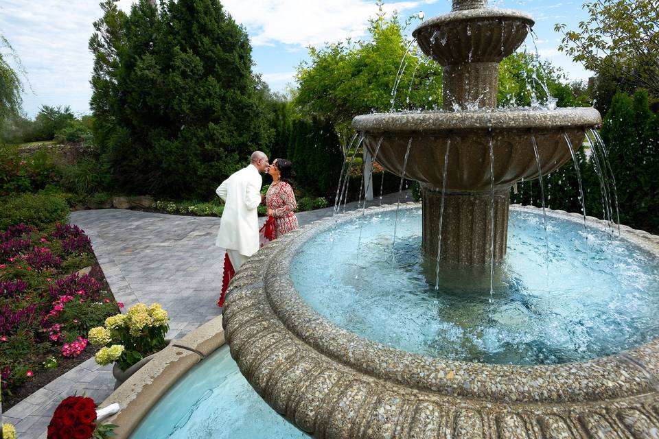 Couple kiss by the outdoor fountain