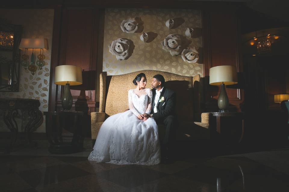 Couple sit on couch for portrait