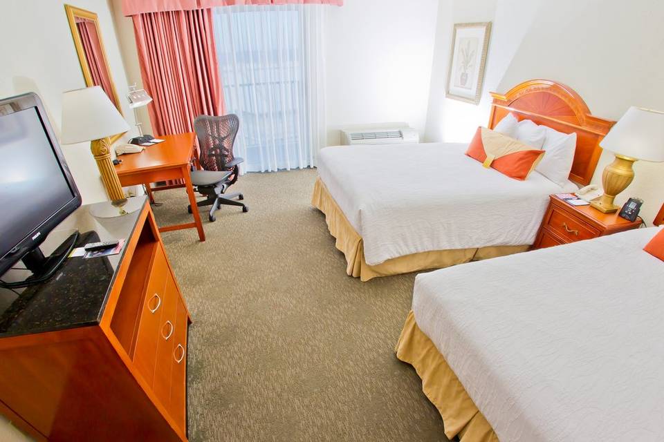 Double queen guest room features a private balcony, microwave, mini refrigerator, coffee maker, and complimentary high speed wired and wireless internet access.