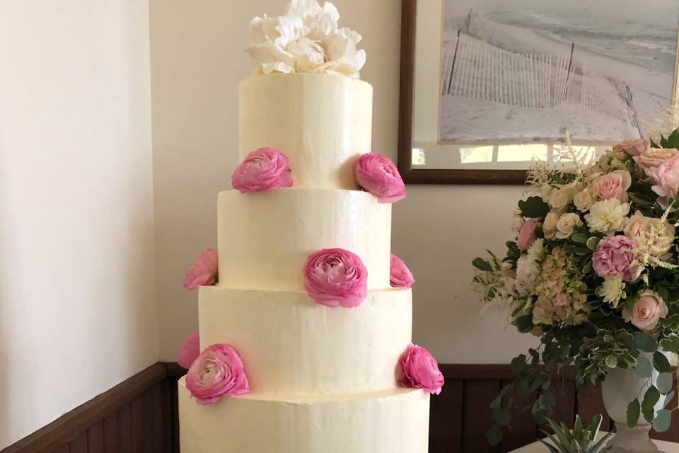 Buttercream with fresh ranunculus and sugar flower on top