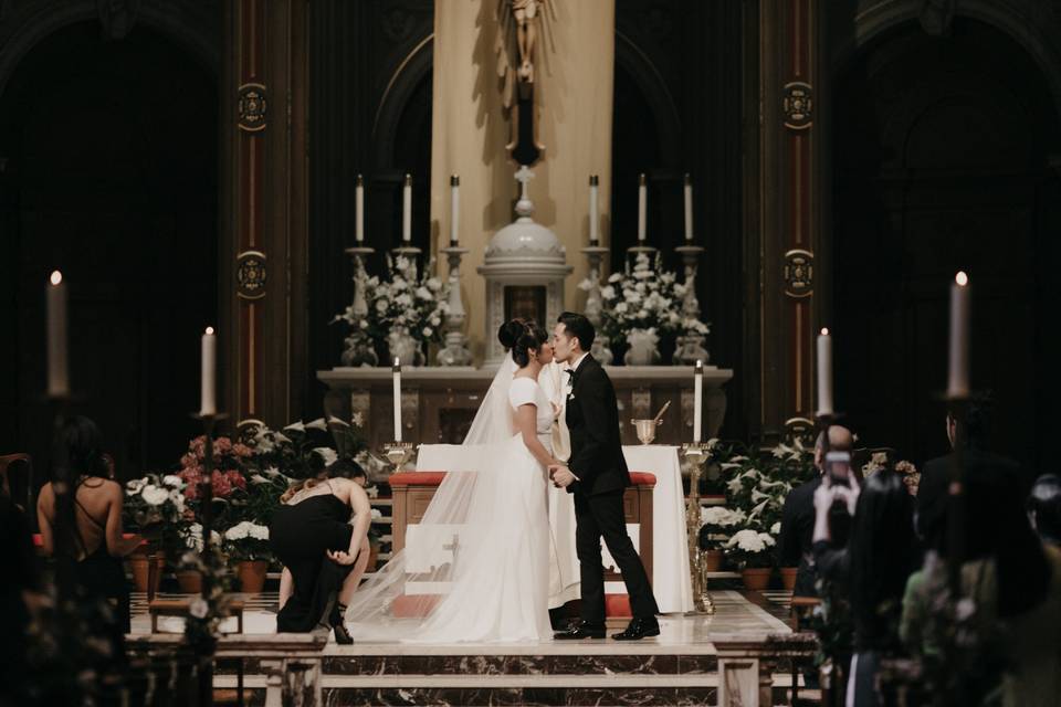 Newlyweds kiss at the altar