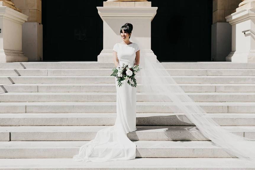 Bride posing by the steps