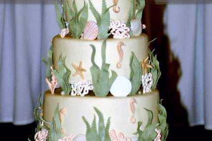 Sugar shells, sand dollars, sea grass and pearls on smooth buttercream tiers.....