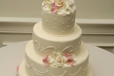 Hand-made sugar hydrangeas and roses on smooth buttercream tiers.....