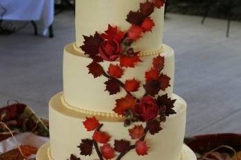 Branches of hand-made sugar fall leaves on smooth buttercream tiers.....