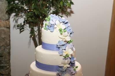 Sugar hydrangeas, hypericum berries and orchids cascading down buttercream tiers....