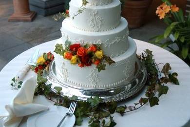 Mmmmmm.....white chocolate curls surrounding the tiers, and topped with a bouquet of hand-made sugar peonies......