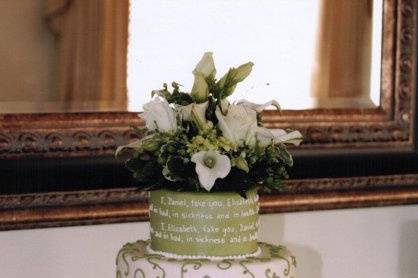 Wedding vows atop whimsical buttercream tiers