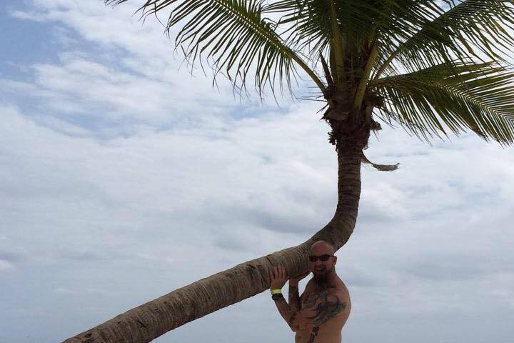 Kenny making sure the palm tree isn't falling.. Mexico was a lot of fun!