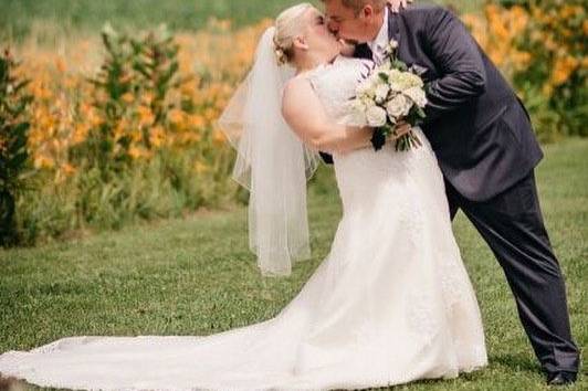 Newlyweds dip for a kiss