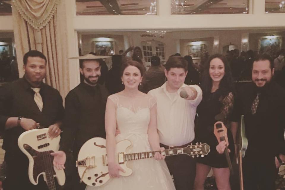 Bride carries the band's guitar