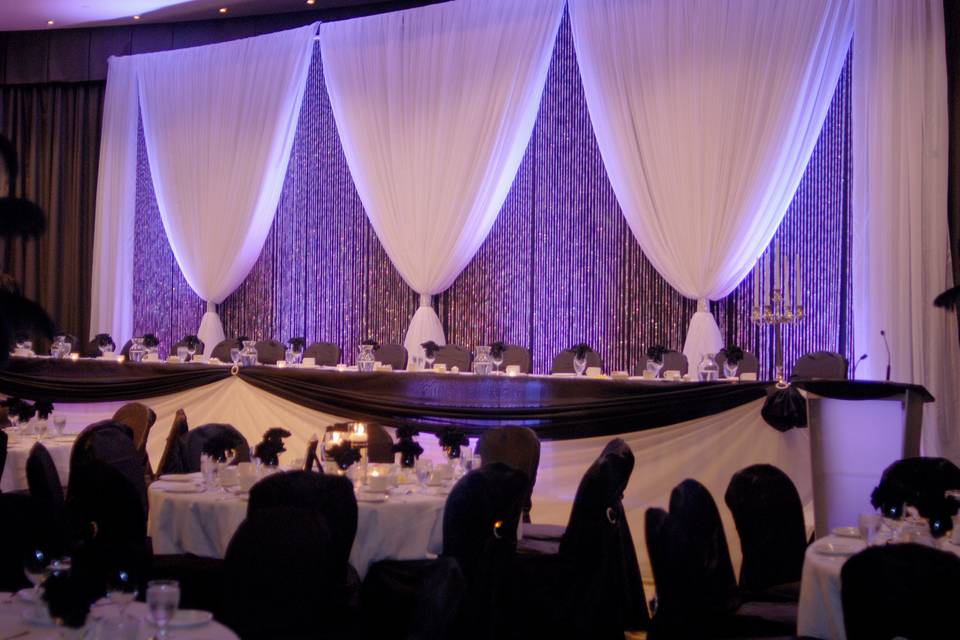 Double back drop with crystals accented by purple uplighting