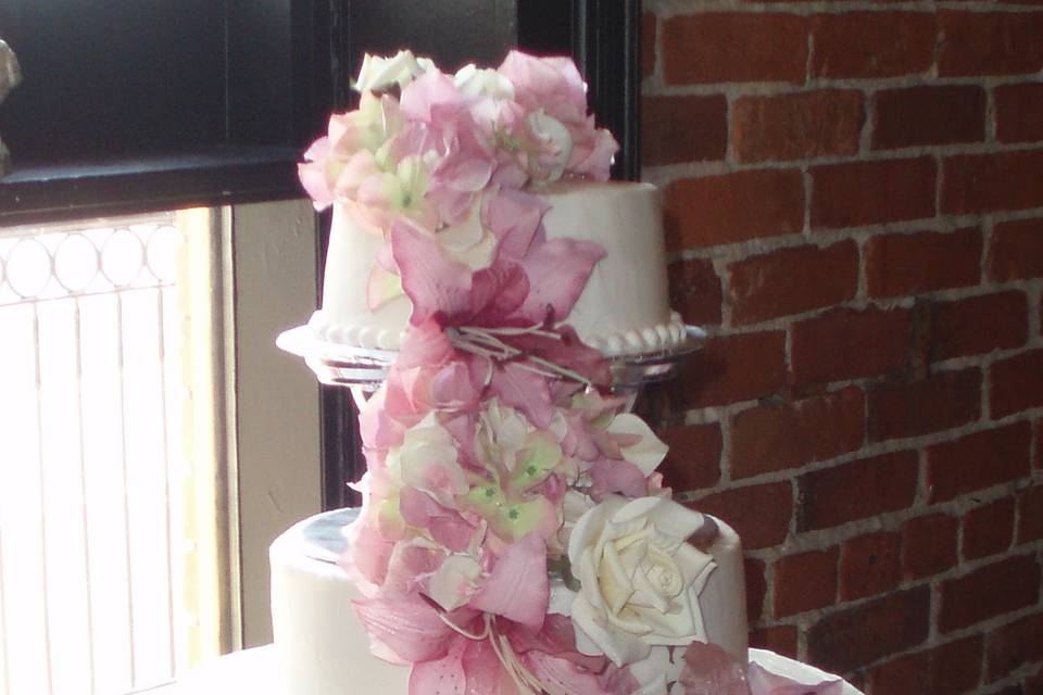 Pink flowers on wedding cake