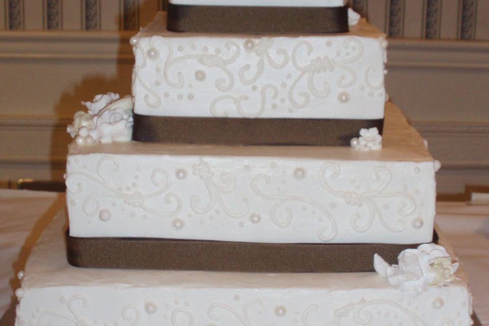 4-tier cake with brown ribbons