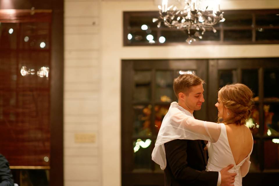 Couple dancing beneath a chandelier