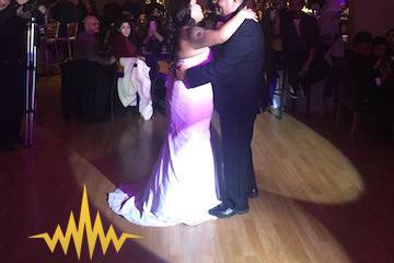 Father and daughter dance with spot light