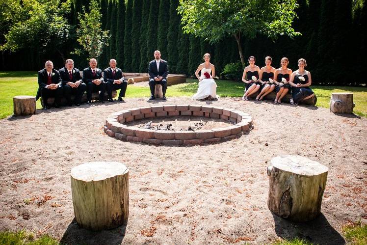 Wedding party posing near fire pit