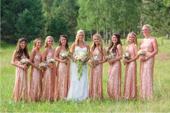 Bridal party posing with fresh bouquets