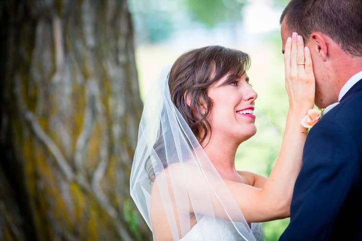 Newlyweds embracing beneath a tree